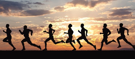Runners running along sunset
